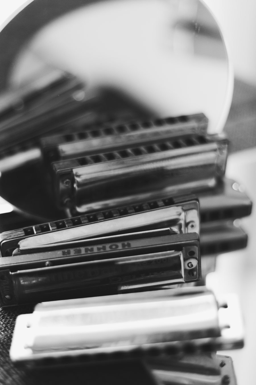 Close-up black and white photo of Federico's Hohner harmonica collection